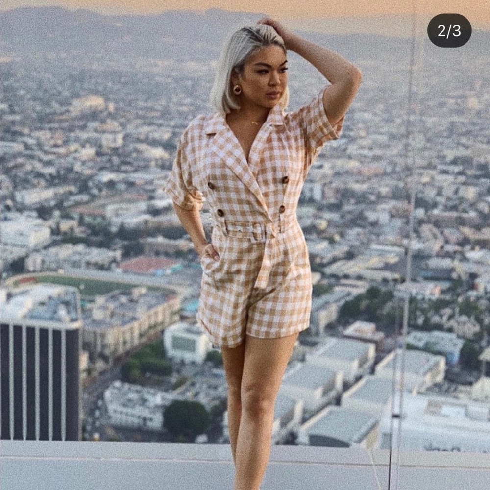 Beige plaid jumpsuit with belt.